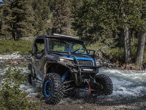 Blue Polaris® General® 1000 EPS UTV driving through creek in the woods