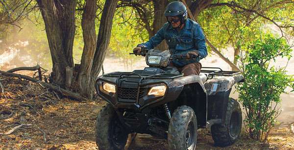 A man riding a 2014 Honda Fourtrax on a jungle track in Union City, TN